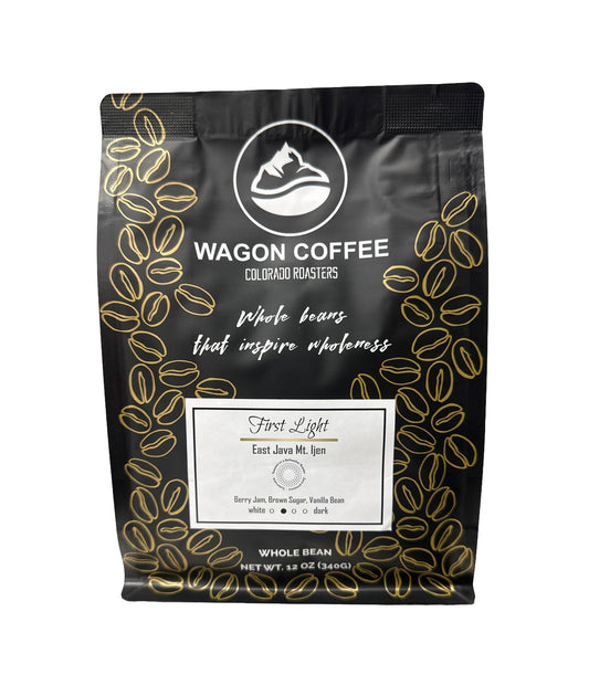 A 12 oz bag of Wagon Coffee Colorado Roasters Whole Bean coffee, specifically 'First Light' (East Java Mle. 159).